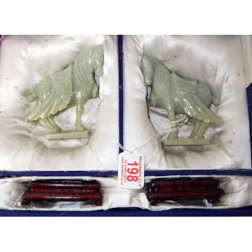 198 - A pair of circa 1960s / 1970s Chinese jade carved warhorses on wooden stands
