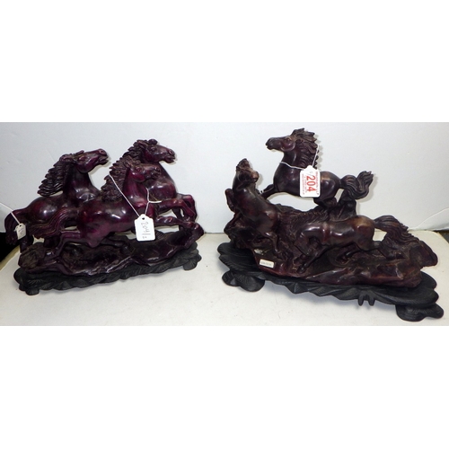 204 - An Oriental carved and polished stone horse sculpture