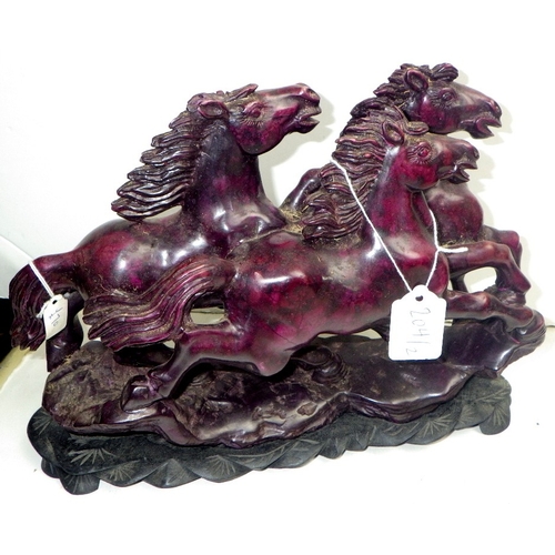 204 - An Oriental carved and polished stone horse sculpture