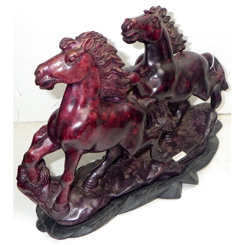 204 - An Oriental carved and polished stone horse sculpture