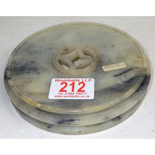 212 - An Oriental carved and polished stone base