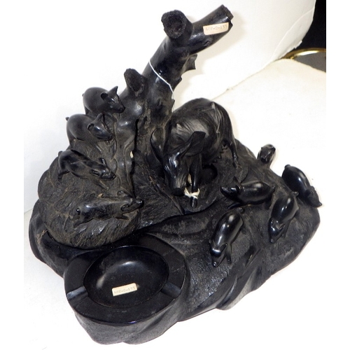 219 - An Oriental carved and polished stone figure of a sow and her litter