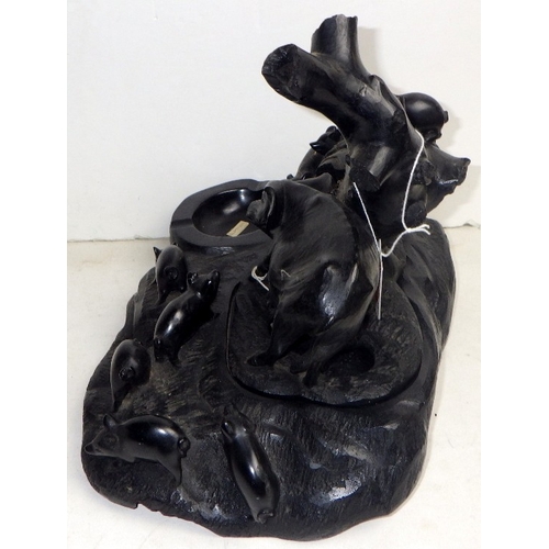 219 - An Oriental carved and polished stone figure of a sow and her litter