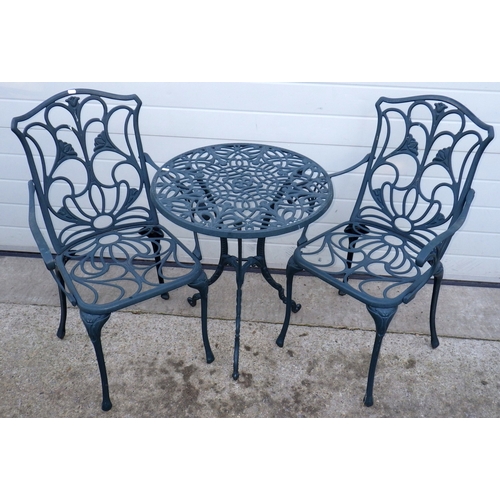 677 - A green painted aluminium garden table, 61cm across, with pair of chairs (3)