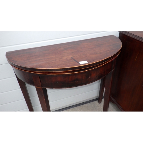 696 - A mahogany demi-lune tea table together with a cupboard (2) (a/f)