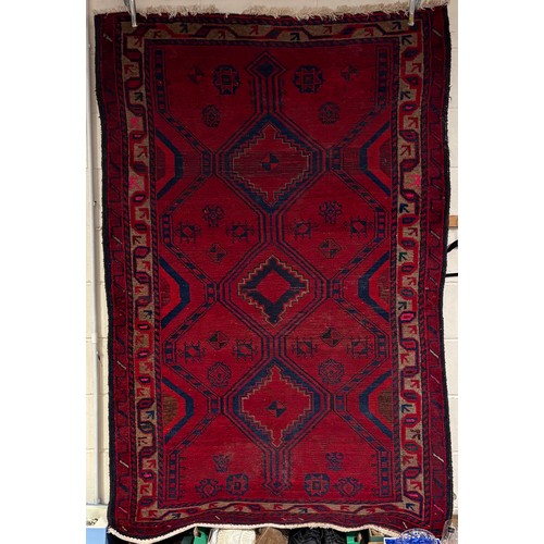 706 - An Afghan red ground rug AF worn, damp 130 x 210cm