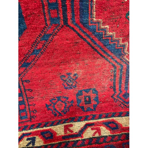 706 - An Afghan red ground rug AF worn, damp 130 x 210cm