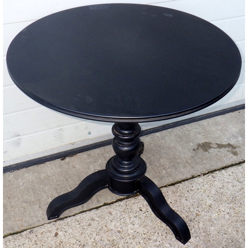 740 - A stained black circular tri-pod table, 70cm across