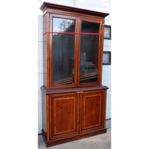 724 - A mahogany & satinwood banded two section bookcase, 138cm wide, 246cm tall