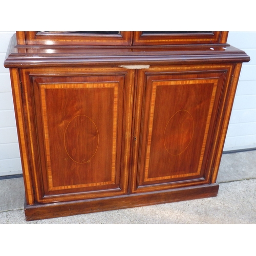 724 - A mahogany & satinwood banded two section bookcase, 138cm wide, 246cm tall