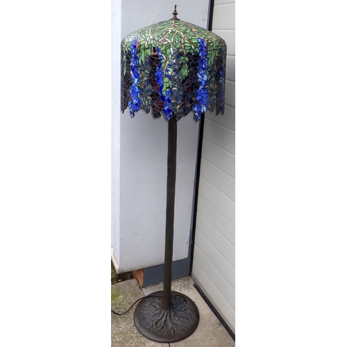 A Tiffany style standard lamp, on a naturalistic base, 170cm tall