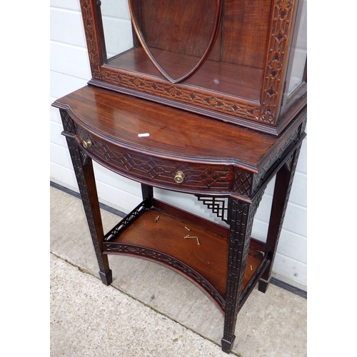 753 - An Edwardian Chippendale style fretwork decorated narrow cabinet on stand, 190cm tall, 61cm wide