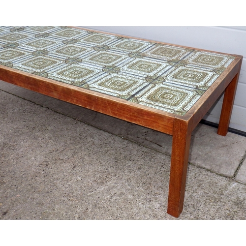 768 - A tile topped teak coffee table, 146cm x 66cm