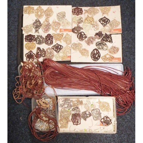 242 - A qty  of Chinese carved soapstone and other amulet pendants; associated unused leather thonging, wh... 