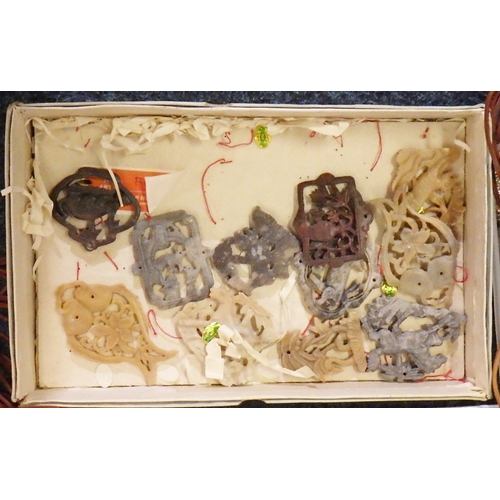 242 - A qty  of Chinese carved soapstone and other amulet pendants; associated unused leather thonging, wh... 
