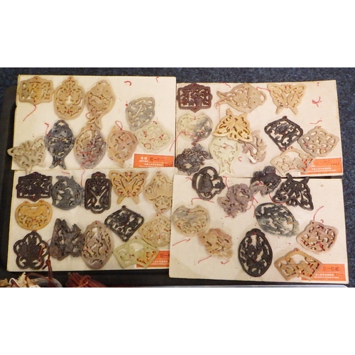 242 - A qty  of Chinese carved soapstone and other amulet pendants; associated unused leather thonging, wh... 