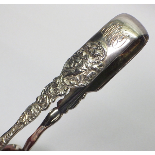 7 - An Edwardian serving tongs, white metal marked Sterling.  165mm long.  The tongs weigh 72g - please ... 