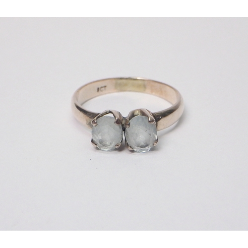 33 - A two stone ring, yellow metal marked 9ct, believed to be of African origin.  The ring weighs approx... 