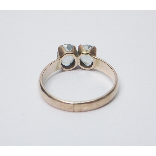 33 - A two stone ring, yellow metal marked 9ct, believed to be of African origin.  The ring weighs approx... 
