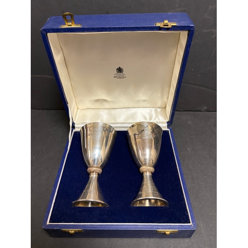 13 - A pair of Mappin & Webb Elizabeth II Royal Silver Wedding silver goblets designed by Colin Hillier, ... 