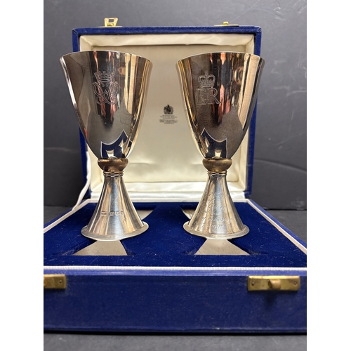 13 - A pair of Mappin & Webb Elizabeth II Royal Silver Wedding silver goblets designed by Colin Hillier, ... 