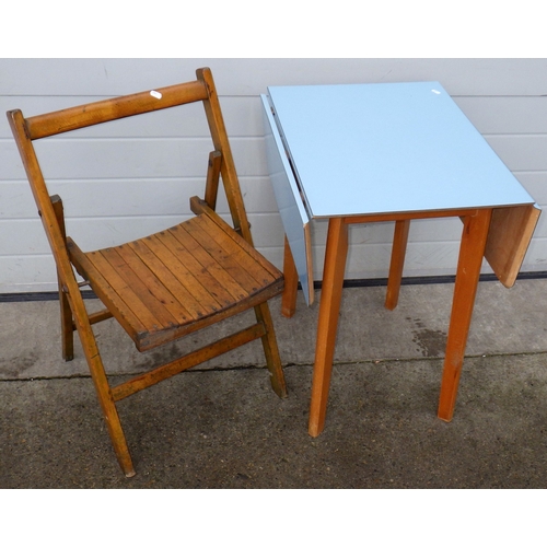 612 - A blue formica topped small drop leaf table together with a folding chair (2)
