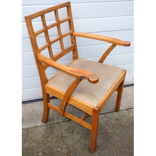 614 - An oak Arts & Crafts elbow chair, with lattice back