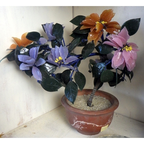 129 - An Oriental carved and polished stone base together with a pair of Oriental glass bonsai trees in te... 