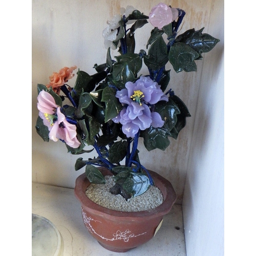 129 - An Oriental carved and polished stone base together with a pair of Oriental glass bonsai trees in te... 