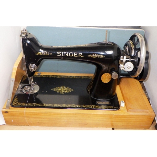 308 - A cased Singer sewing machine together with a wooden box containing accessories
