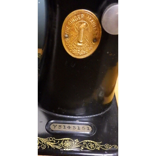 308 - A cased Singer sewing machine together with a wooden box containing accessories