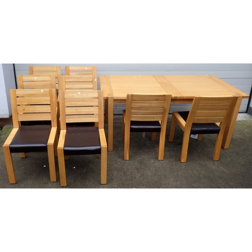 639 - A modern light oak extending dining table with one leaf, 180cm closed x 100cm together with eight ch... 