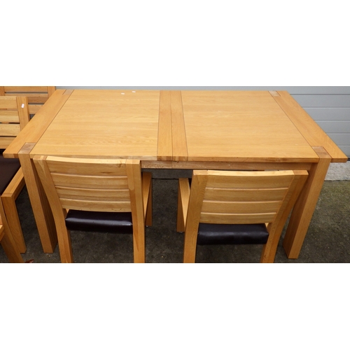 639 - A modern light oak extending dining table with one leaf, 180cm closed x 100cm together with eight ch... 