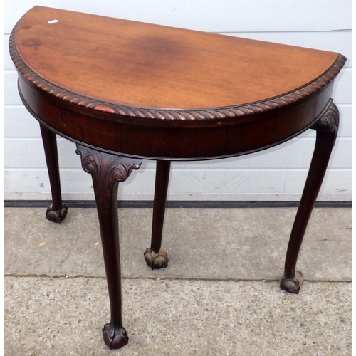 648 - A 1930's mahogany demi-lune card table on ball & claw feet, 87cm wide
