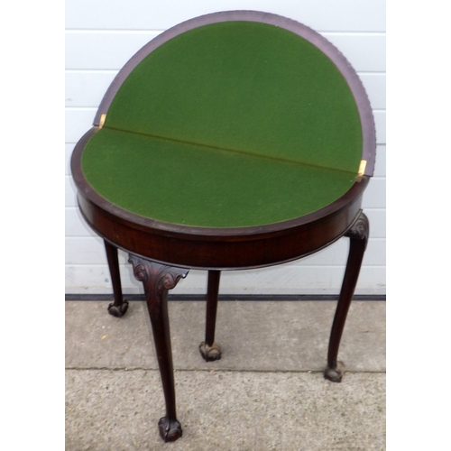 648 - A 1930's mahogany demi-lune card table on ball & claw feet, 87cm wide