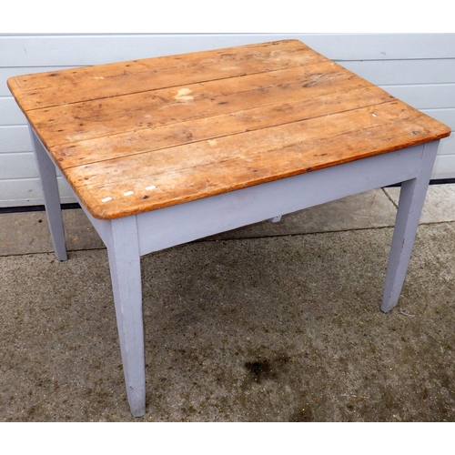 678 - A pine topped kitchen table on painted legs, drawer filled in, 114cm x 92cm