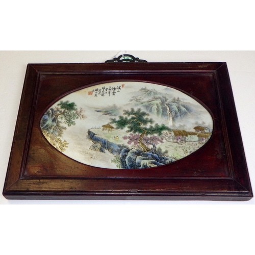 354 - A 20thC Chinese porcelain plaque with a landscape scene, set in a hardwood frame 40 x 28cm