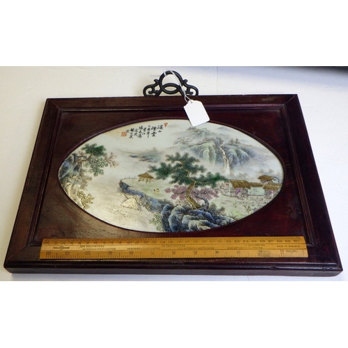 354 - A 20thC Chinese porcelain plaque with a landscape scene, set in a hardwood frame 40 x 28cm