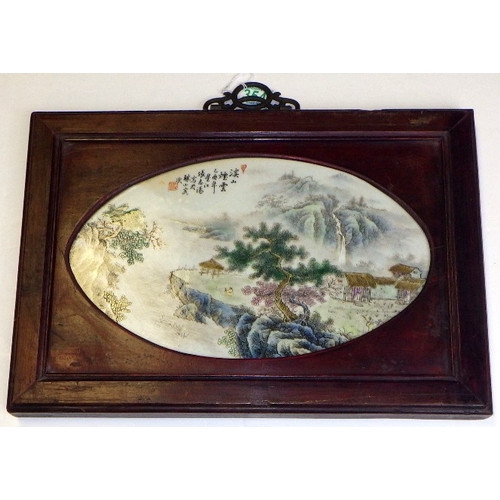 354 - A 20thC Chinese porcelain plaque with a landscape scene, set in a hardwood frame 40 x 28cm