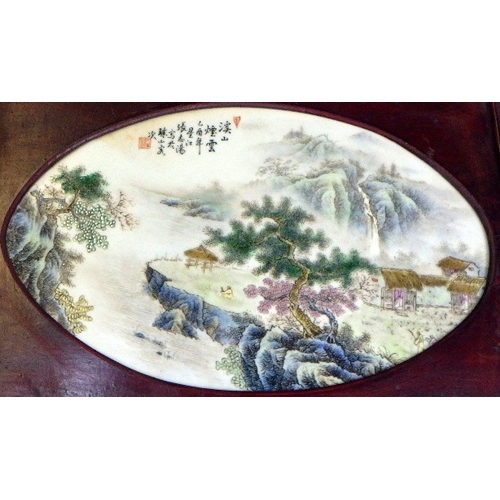 354 - A 20thC Chinese porcelain plaque with a landscape scene, set in a hardwood frame 40 x 28cm
