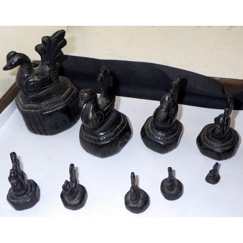 383 - A group of graduated sets of Burmese cast opium weight markers