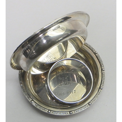 24 - A pair of silver nut dishes, a silver napkin ring.  Dishes 88mm diameter / 115g  total.