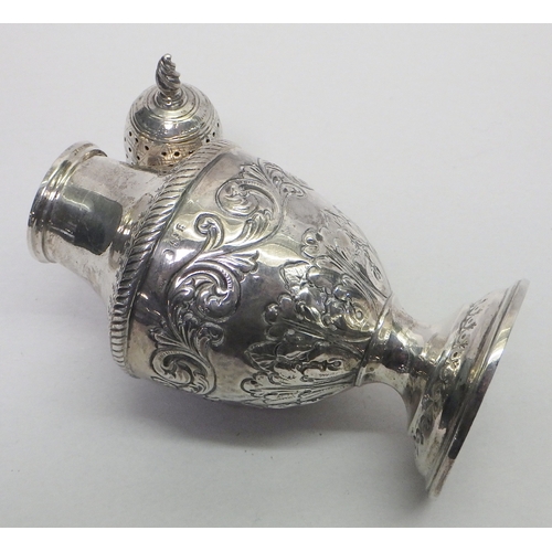 25 - A silver repousse caster, hallmarks rubbed.  Approx 165mm tall / 130g