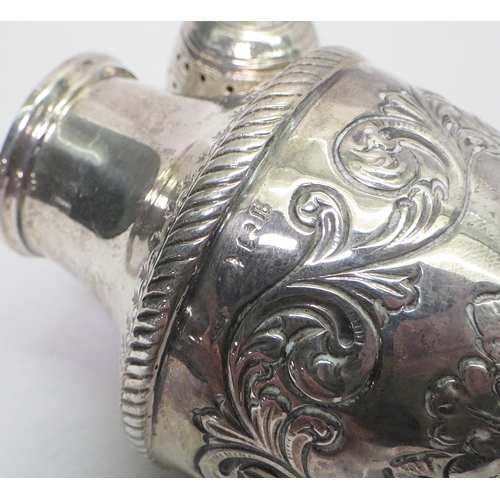 25 - A silver repousse caster, hallmarks rubbed.  Approx 165mm tall / 130g