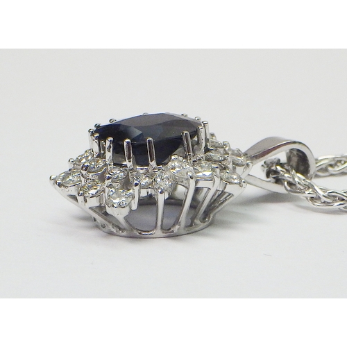 31 - A cluster pendant comprising an oval sapphire surrounded by 28 diamonds of round an marquise cuts, u... 