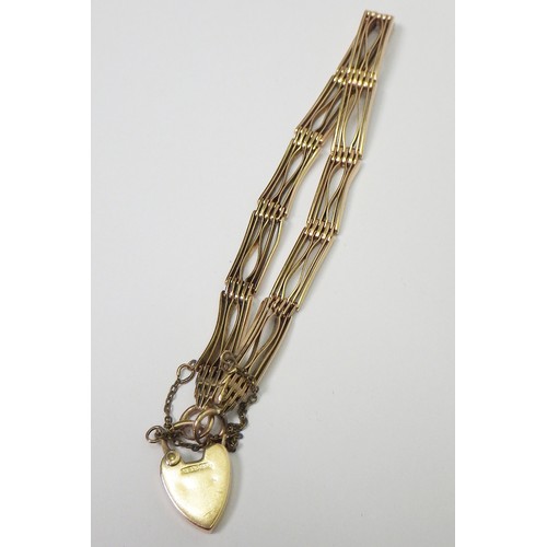 35A - A slim fancy gate link bracelet, unmarked yellow metal, the padlock clasp marked 15c.   The bracelet... 