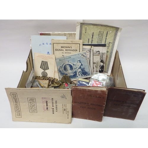 96 - Militaria to include Soldier's Record and Pay Book 1940s / 1950s; badges; identity tags; a WW2 servi... 