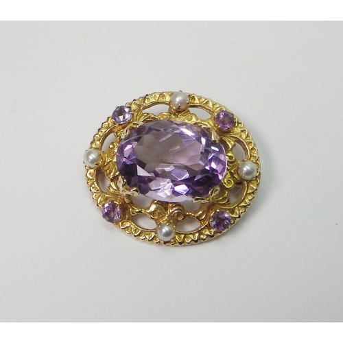 39 - A 9ct gold cluster brooch set with amethysts and pearls, Edinburgh 1960.  32 x 28mm oval / central s... 