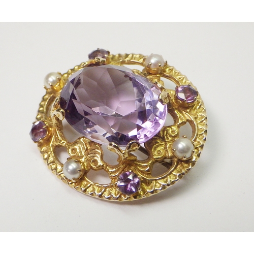 39 - A 9ct gold cluster brooch set with amethysts and pearls, Edinburgh 1960.  32 x 28mm oval / central s... 