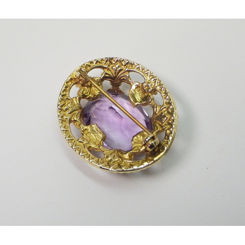 39 - A 9ct gold cluster brooch set with amethysts and pearls, Edinburgh 1960.  32 x 28mm oval / central s... 